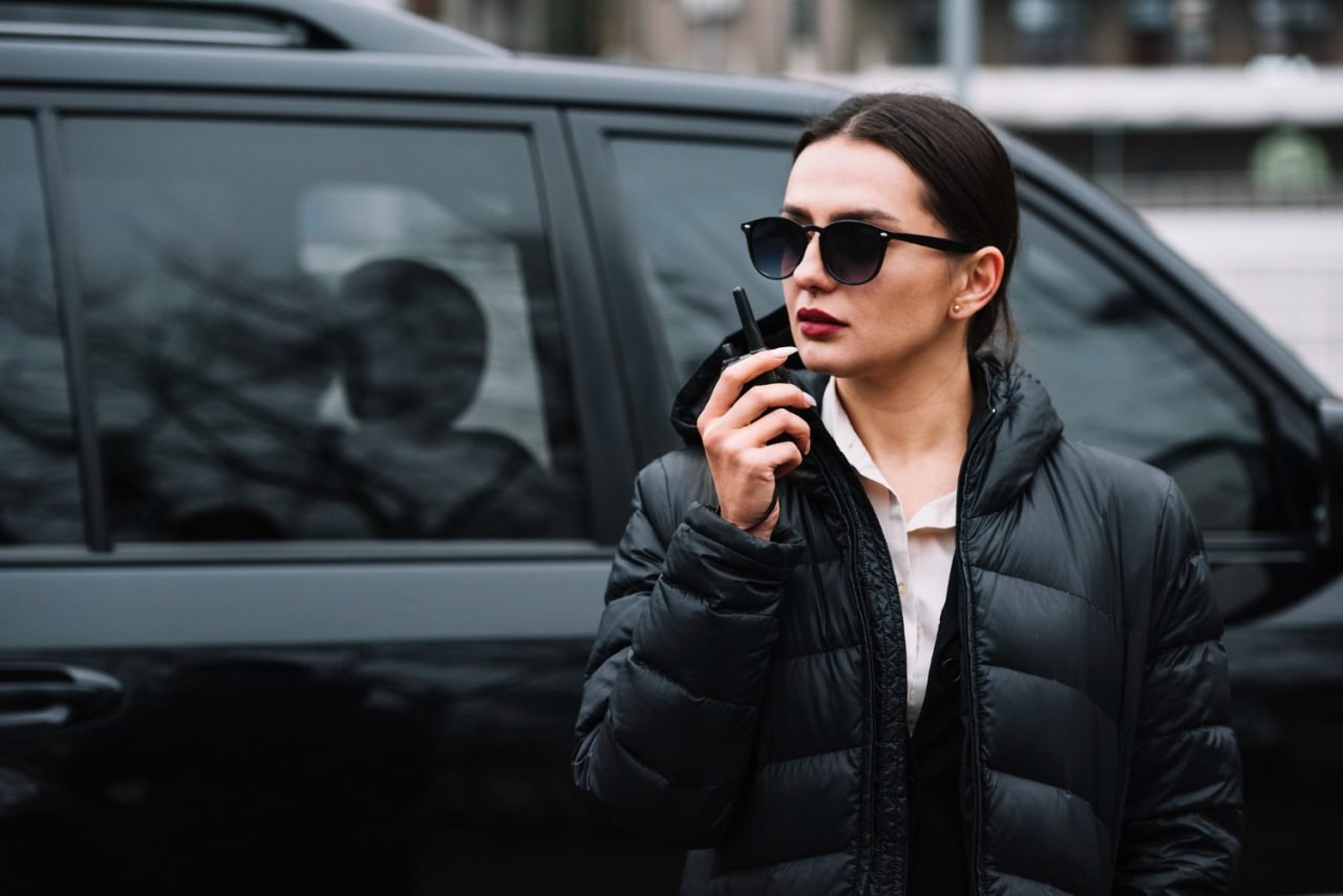 Female security officer in uniform with radio equipment